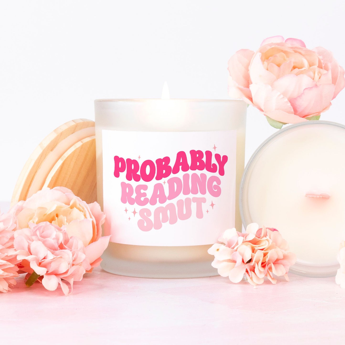 Probably reading smut pink retro style font funny quote. Pink wick candle in a frosted glass.