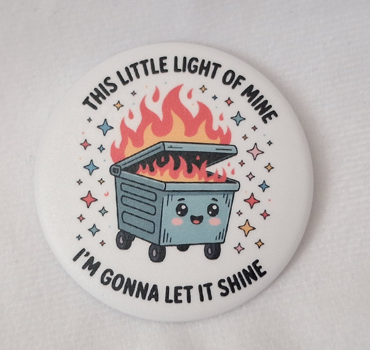 Button badge with a cartoon dumpster fire and text on a white background.